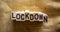 Wooden blocks form the word `lockdown` on beautiful canvas background