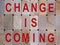 Wooden blocks form the words `change is coming`. Beautiful wooden background