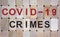 Wooden blocks form the words `covid-19 crimes`. Beautiful wooden background