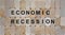 Wooden blocks form the words `economic recovery`. Beautiful wooden background. Business concept