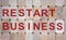 Wooden blocks form the words `restart business`. Beautiful wooden background