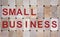 Wooden blocks form the words `small business`. Beautiful wooden background