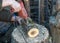 Wooden blocks, human hand holding a drill, drilling holes in a wooden log