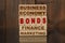 Wooden blocks with the text - Business, Economy, Finance, Marketing and BONDS