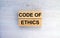 Wooden blocks with text Code of Ethics on the wooden background