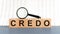 Wooden Blocks with the text: Credo with magnifying glass