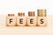 Wooden blocks with text FEES on wooden table