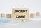 Wooden blocks with text Urgent Care with mask and thermometer