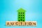 Wooden blocks with the word Auction and miniature house. Real estate public sale concept. Auction method of selling housing.