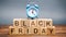 Wooden blocks with the word Black Friday and the clock. Sale and discounts. Low prices. Thanksgiving Day
