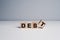 Wooden blocks with the word debt. Mortgages and car loans. Bonds, life in debt