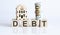 Wooden blocks with the word For DEBT Real estate concept. Rent apartment. Property