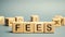 Wooden blocks with the word Fees and randomly scattered cubes. Fixed price charged for a specific service. Business and finance