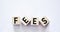 Wooden blocks with the word Fees on a white background. Fixed price for a specific service. Cost, fees and taxes