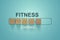 Wooden blocks with the word FITNESS in the loading bar progress concept