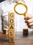 Wooden blocks with the word Goals and businessman. The concept of achieving business goal. Reaching new heights. Execution of a