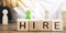 Wooden blocks with the word Hire. Headhunter selects a person from the crowd. Good choice. Human Resource Management. Recruiting