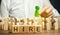 Wooden blocks with the word Hire. Headhunter selects a person from the crowd. Human Resource Management. Recruiting Headhunting.