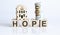 Wooden blocks with the word For Hope Real estate concept. Rent apartment