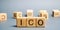 Wooden blocks with the word ICO  Initial coin offering  and calculator. Attracting investments in the form of selling to