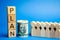 Wooden blocks with the word Plan and a business team standing next to money. Strategy planning. Management business concept.