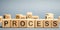 Wooden blocks with the word Process. Business management concept. Litigation and technological processes