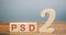 Wooden blocks with the word PSD 2 - Payment Services Directive. European Commission Banking Directive. Increase payment efficiency