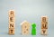 Wooden blocks with the word Rent or buy and a person stands near the house. Make the right decision. Real estate concept. Rent