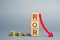 Wooden blocks with the word ROR and arrow down. Financial ratio illustrating the level of business loss. Return on investment.