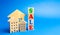 Wooden blocks with the word Sale and wooden miniature houses. The concept of the sell of real estate, apartments and residential