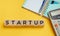 Wooden blocks with the word Startup. The concept of raising funds for a startup