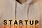 Wooden blocks with the word Startup. Temporary structure designed to find and implement a scalable business model. The concept of