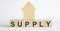 Wooden blocks with the word SUPPLY , house. The concept of the high cost of rent for an apartment or home. Interest rates are