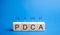 Wooden blocks with words PDCA Plan do check act. Business goals and strategy concept. Plan, planning. Performance, management