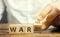 Wooden blocks with the words War, yes and no. Conflict between political states and factions. Armed confrontation, military and