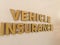 Wooden blockswith words vehicle Insurance. Wooden blocks with lettering on top of white background. Insurance concepts