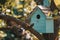 Wooden blue birdhouse on a apple tree in the farm park zone.