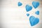 Wooden blue hearts on timbered background, space for text.