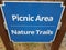 wooden blue picnic area nature trails sign