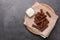 Wooden board with crispy rusks and dip sauce on grey table, top view. Space for text