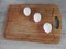 Wooden board for cutting foods on the table in the kitchen.