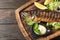 Wooden board with delicious grilled fish on table