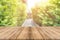 Wooden board empty table blur trees in forest background - can be used mock up for display or montage your products.