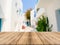 Wooden board empty table in front of blurred hotel building background. Perspective brown wood over blur hotel.