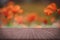 Wooden board empty table in front of orange California poppies.