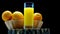 On a wooden board Freshly squeezed orange juice in a glass on a black background. Oranges in a basket with fresh yellow lemonade