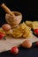 Wooden board with pasta, cherry tomatoes, two eggs and a grinding bowl