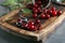 Wooden board with ripe cherries on grey table