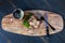 Wooden board with sauteed mushrooms and steak dinner.