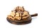 Wooden board with tasty pancakes, sliced banana and walnuts on white background